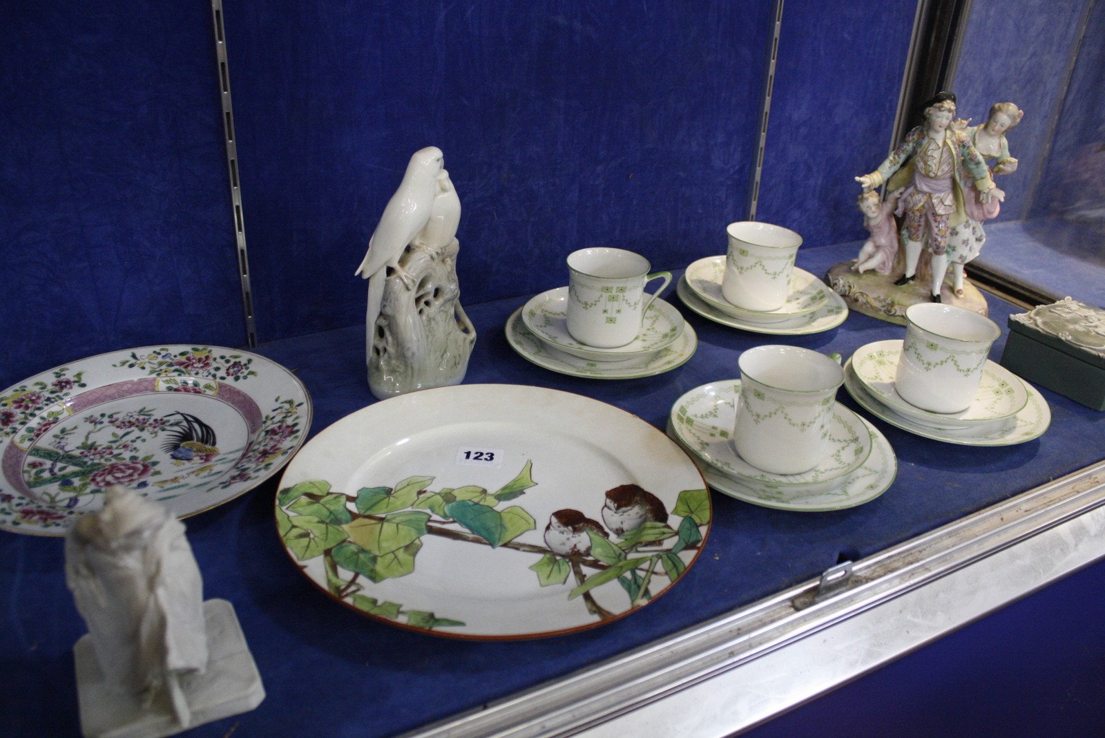 An assortment of ceramics and porcelain to include a Royal Copenhagen model of parrots, a part tea