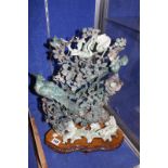 A Chinese jadeite carving with birds and flowers, on wooden stand, 43cm high