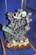 A Chinese jadeite carving with birds and flowers, on wooden stand, 43cm high