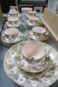 A Royal Worcester part tea service, decorated with a border of pink roses within gilt C-scroll and