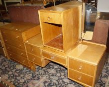 A 1950's Meredew oak bedroom suite of four pieces, chest, dressing table, bedside, and wardrobe.