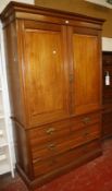 An Edwardian walnut linen press with a shelved upper section and drawers to the base..207cm high x