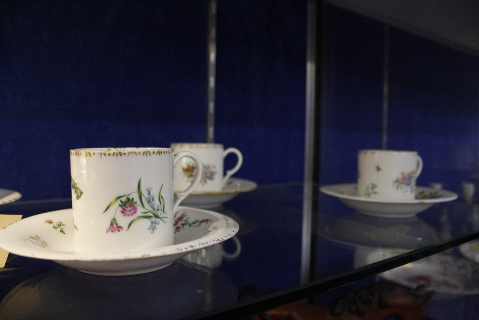 A set of six Meissen (outside decorated) coffee cans and saucers, blue crossed swords and