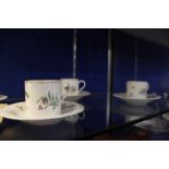 A set of six Meissen (outside decorated) coffee cans and saucers, blue crossed swords and