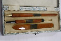 A Bakelite writing set, the fountain dip pen with 14ct gold plated nib, a propelling pencil, all