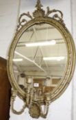 A Victorian gilt composition oval wall mirror with shell decoration 95cm high, 57cm wide