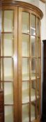 A demi lune pine display cabinet with central glazed cupboard door 210cm high, 108cm wide