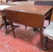 A George III mahogany Pembroke table on slender tapered supports. Best Bid