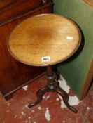 A slender Georgian style mahogany tripod table; and a Vono green baise covered card table.