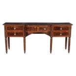 A George III mahogany sideboard, circa 1800, the shaped top above a bowed central drawer and