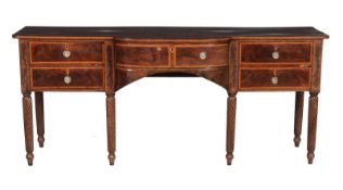 A George III mahogany sideboard, circa 1800, the shaped top above a bowed central drawer and