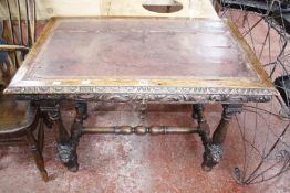 A Victorian carved oak writing table with leather top 105cm wide