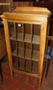 A mid 20th century light oak display cabinet. Best Bid