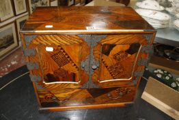 A 19th century Japanese parquetry table top cabinet, metal mounts, cupboard enclosing six small