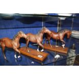 Four modern Beswick horses, three on wooden plinths, (one af), 20 - 23cm high approx.