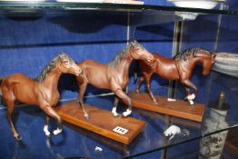Four modern Beswick horses, three on wooden plinths, (one af), 20 - 23cm high approx.