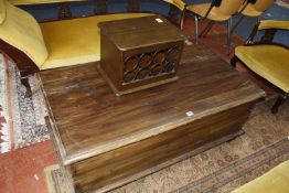 A coffee table with three rows of drawers and a hinged lid, together with a wine rack