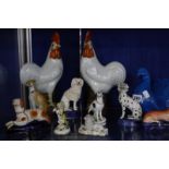 A selection of porcelain and pottery model dogs, a 19th Century Staffordshire model dog, a pair of