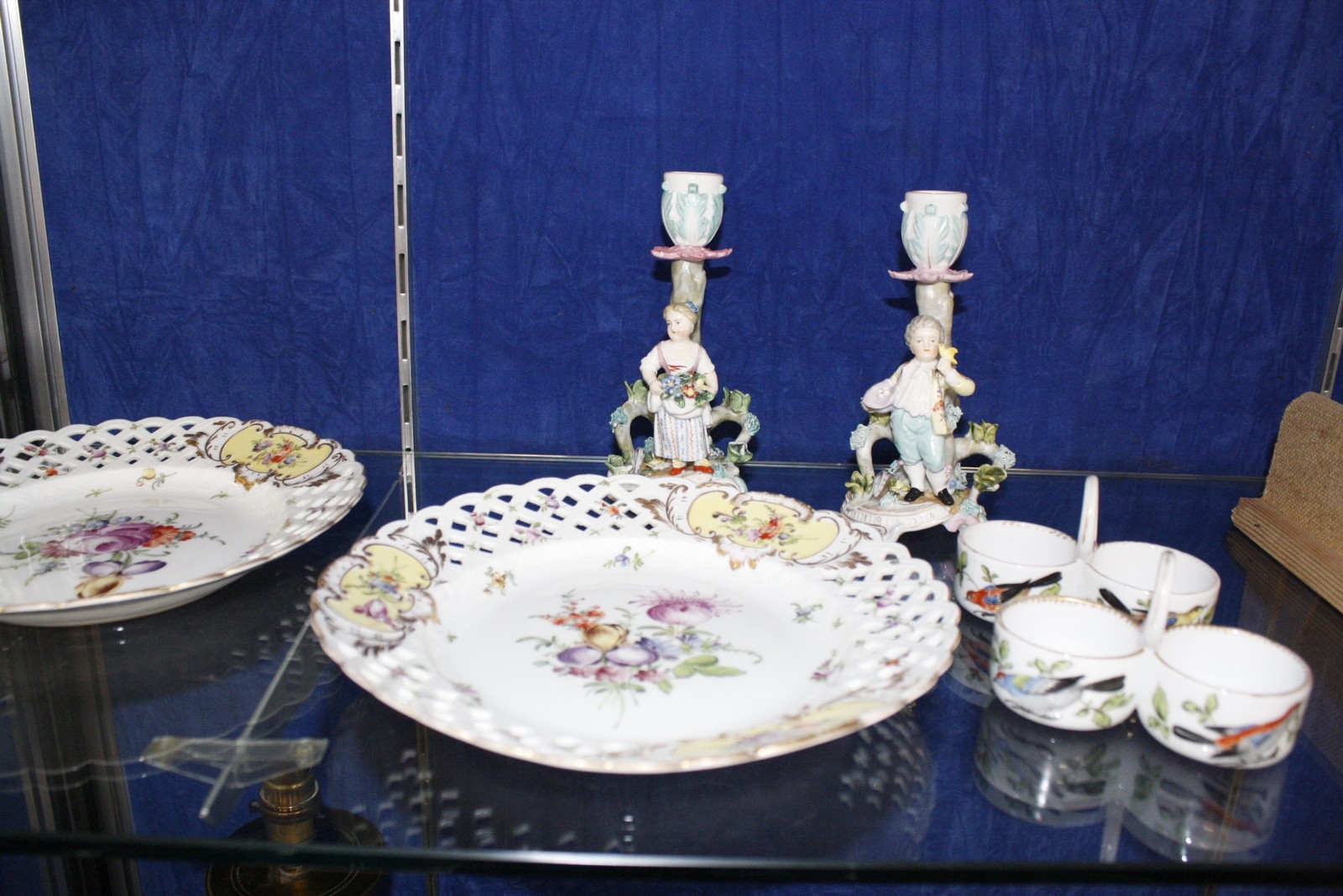 A selection of Dresden porcelain, comprising; a pair of plates decorated with flowers within pierced