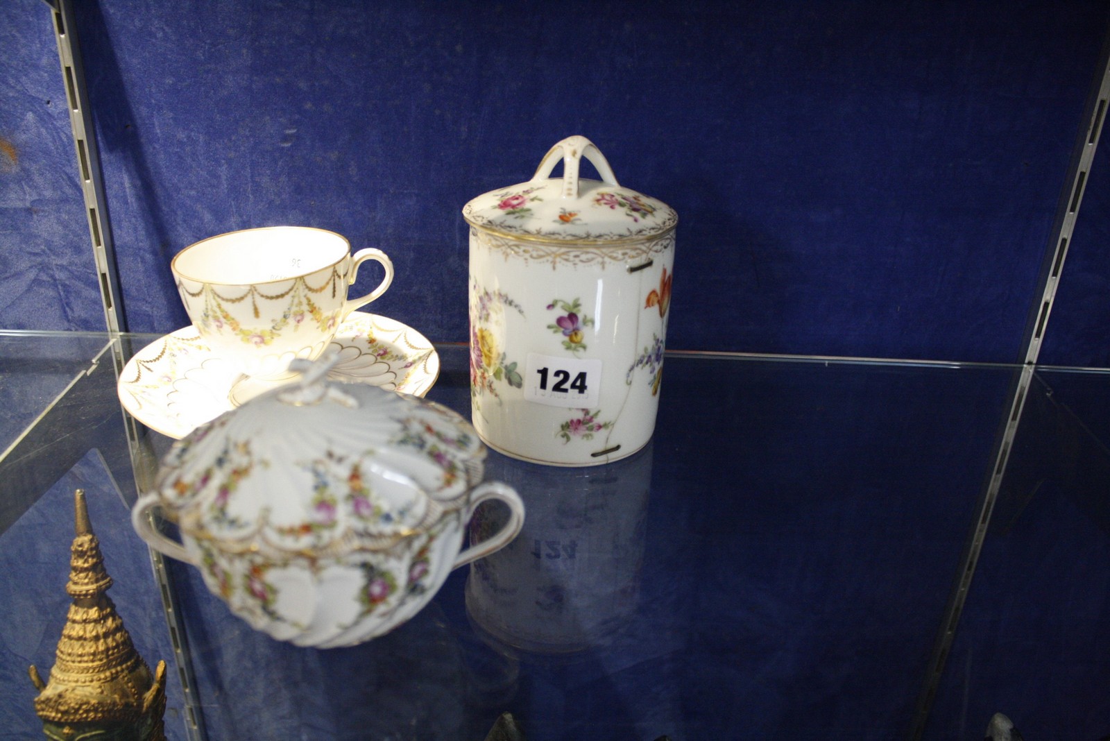 A Dresden tea cup and saucer, foliate with gilt swags, with S under blue crossed swords mark to