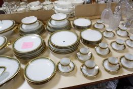 A Limoges part dinner and coffee service, green and gilt border, comprising tureens, soup bowls,