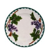 A Wemyss plate, circa 1890, painted with blue and black grapes, impressed  A Wemyss plate, circa