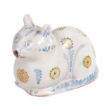 A tin-glazed earthenware cat flask, naturalistically modelled as recumbent cat  A tin-glazed