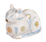 A tin-glazed earthenware cat flask, naturalistically modelled as recumbent cat  A tin-glazed