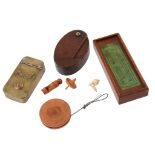 A fruitwood yo yo, mid 19th century, 4.7cm diameter; a mahogany boxed set of...  A fruitwood yo yo,