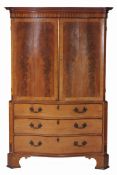 A George III mahogany linen press , circa 1770 and later, of serpentine outline  A George III