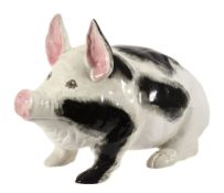 A Wemyss black and white pig, circa 1900, with pink ears and the eyes with...  A Wemyss black and
