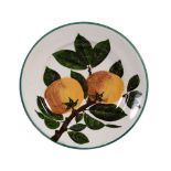 A Wemyss plate, circa 1900, painted with a branch of two oranges, impressed  A Wemyss plate, circa