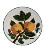 A Wemyss plate, circa 1900, painted with a branch of two oranges, impressed  A Wemyss plate, circa