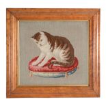 A Victorian framed and glazed needlework picture of a cat on a cushion  A Victorian framed and