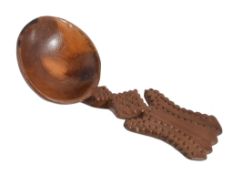 A fruitwood treen caddy spoon, circa 1800, with a chip carved shaped handle  A fruitwood treen caddy