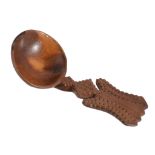 A fruitwood treen caddy spoon, circa 1800, with a chip carved shaped handle  A fruitwood treen caddy