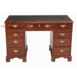 A mahogany pedestal desk in the George III style, late 19th/early 20th century  A mahogany