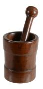 A turned and stained walnut mortar and pestle, 18th century  A turned and stained walnut mortar