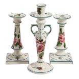 A pair of Wemyss candlesticks, circa 1910, painted with pink roses  A pair of Wemyss candlesticks,