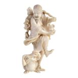 An Ivory Okimono of Gama Sennin, the immortal cavorting on one leg as small...  An Ivory Okimono