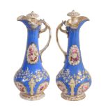 A pair of Staffordshire porcelain 'Rococo revival' ewers and stoppers  A pair of Staffordshire