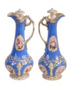 A pair of Staffordshire porcelain 'Rococo revival' ewers and stoppers  A pair of Staffordshire