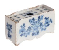 An English delft blue and flower-brick, circa 1760  An English delft blue and flower-brick,