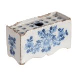 An English delft blue and flower-brick, circa 1760  An English delft blue and flower-brick,