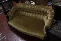 A small Victorian shaped button back settee on mahogany cabriole front supports.133cm wide.
