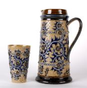 A Doulton Lambeth stoneware ewer and matching beaker by George Tinworth