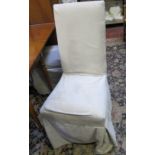 A set of six dining chairs with loose cream cushions