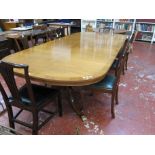 A two piece Regency style mahogany dining / boardroom table raised on two swept pedestals. 306cm x