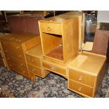 A 1950's Meredew oak bedroom suite of four pieces, chest, dressing table, bedside, and wardrobe.