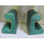 A pair of green leather Harrods retailed book-ends, scrolled shape